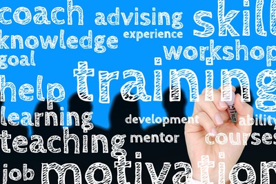 W&ouml;rter wie "Motivation", "Training", "Wissen" und "F&auml;higkeit" sind in verschiedenen Gr&ouml;&szlig;en auf blauem Hintergrund zu sehen.